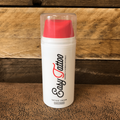 easy tattoo cream aftercare container with red cap on a wooden surface